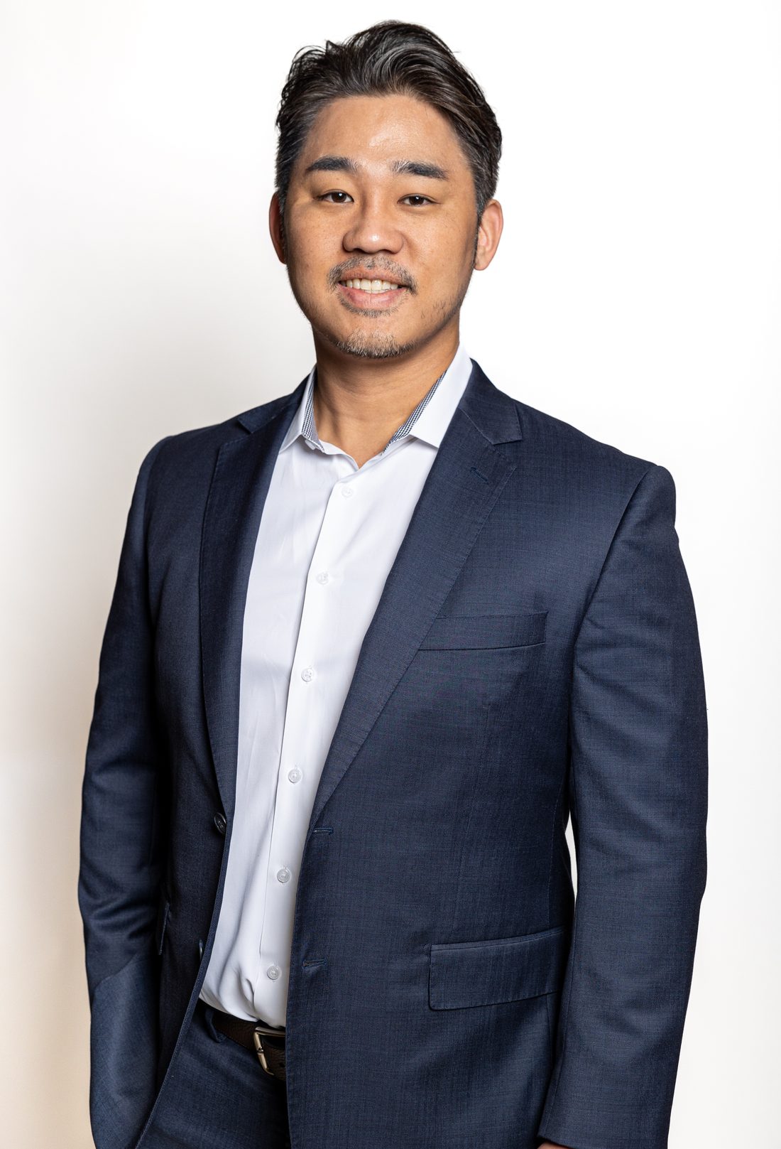 Formal portrait of Dr. Han Choi in a navy suit and white shirt.